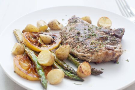 Grilled pork, asparagus and young potatoes の写真素材