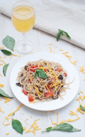 Spaghetti with vegetables and a glass of juice の写真素材