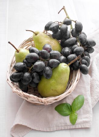 Basket with grapes and pears top viewの写真素材
