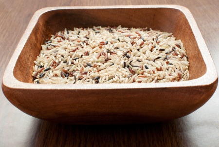 Bowl with uncooked mixed healthy brown, red and black riceの写真素材