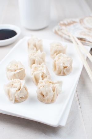 Chinese dumplings eating with chop sticks verticalの写真素材