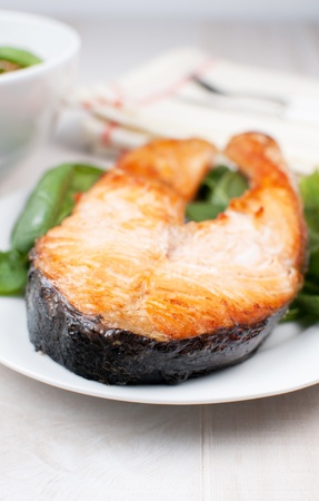 Broiled salmon steak on plate verticalの写真素材