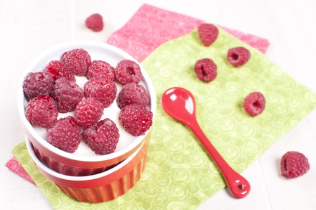 Fresh raspberry with cream or yogurt dessert top view
