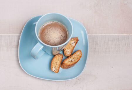 Almond small biscotti and blue cup and plateの写真素材