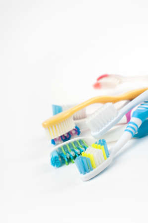 Heap of different multicolored toothbrushes isolatedの写真素材