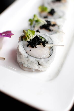 raw scallop sushi with black roe closeupの写真素材