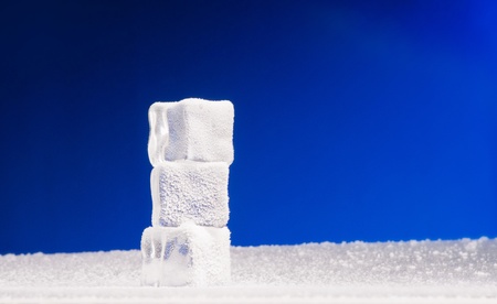 Three clear ice cubes covered with hoarfrostの写真素材