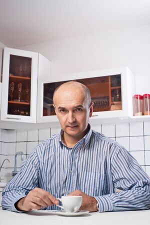 Grave man in the kitchenの写真素材