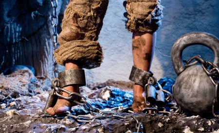 Legs in heavy iron shacklesの写真素材