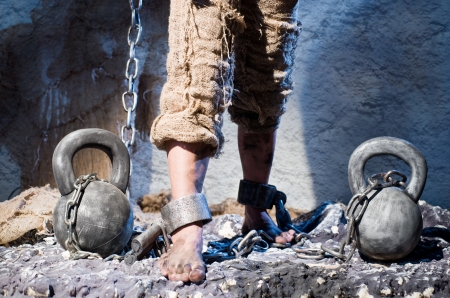 Legs in heavy iron shackles