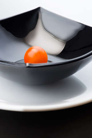 Black plate with cherry tomatoの写真素材