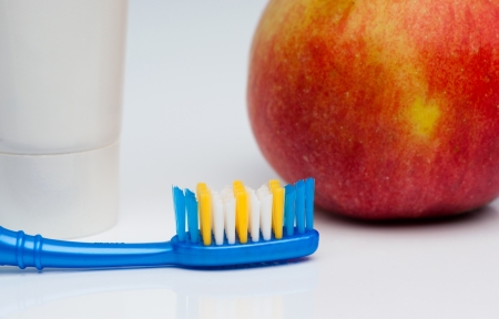 Toothbrush, toothpaste and appleの写真素材