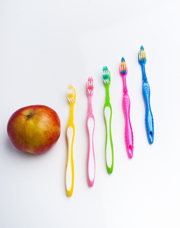 Color toothbrushes and fresh appleの写真素材