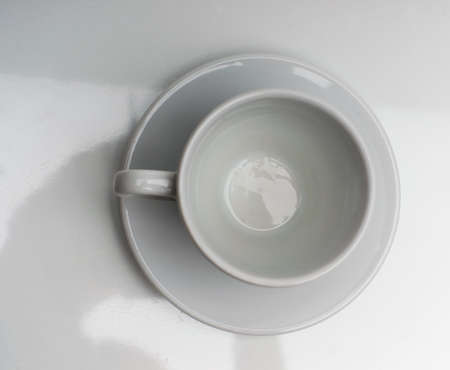 Empty cup and spoon on the saucer