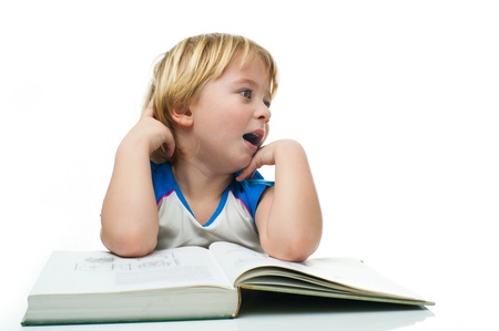 Yawning boy with a bookの写真素材