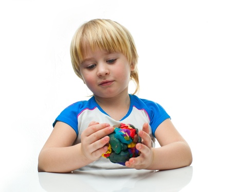 Little boy playing with plasticineの写真素材