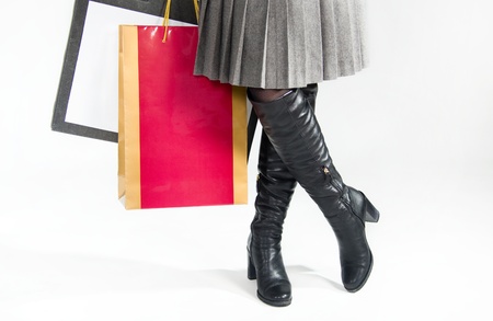 Girl in high boots and with red bagの写真素材