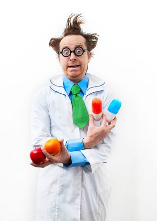 Funny doctor with tablet and fruit in handの写真素材
