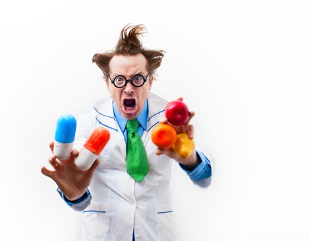 Angry doctor with tablet and fruit in handの写真素材