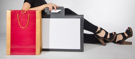 Stylish woman sitting with packages