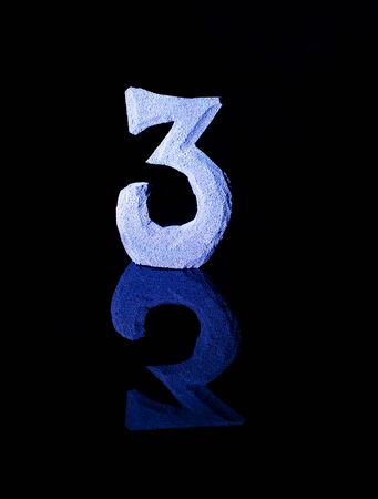 Numeral three on black backgroundの写真素材