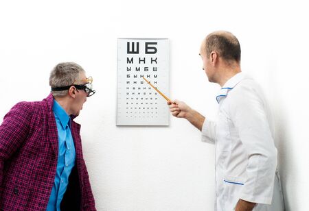 Doctor ophthalmologist and patient funnyの写真素材