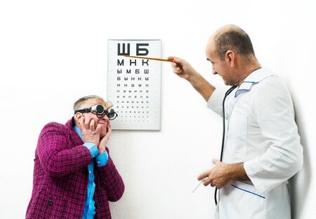 Doctor ophthalmologist and patient funnyの写真素材