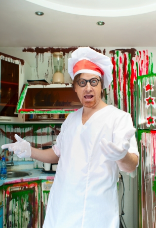 Cheerful cook in the painted kitchenの写真素材