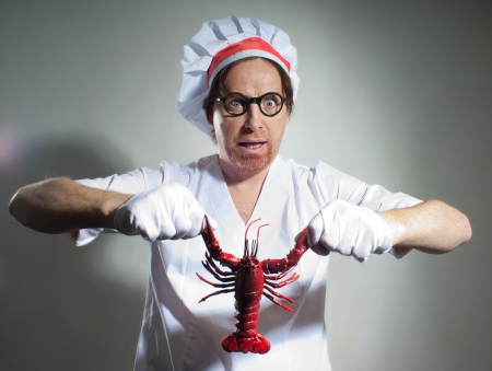 Funny chef with lobster on gray backgroundの写真素材