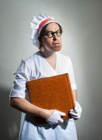 Chef with the cookbook on gray backgroundの写真素材