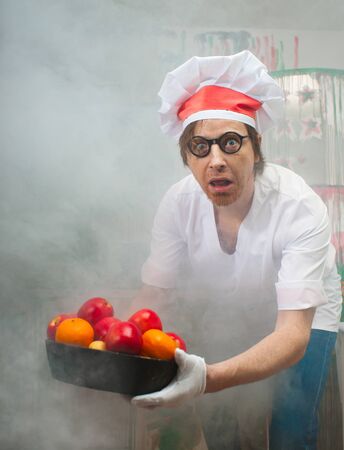 Funny chef with fruit in smokeの写真素材