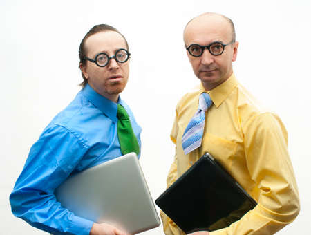Two crazy businessman with laptopsの写真素材
