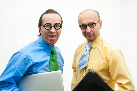 Two crazy businessman with laptopsの写真素材