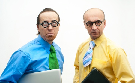 Two thoughtful businessman with laptopsの写真素材