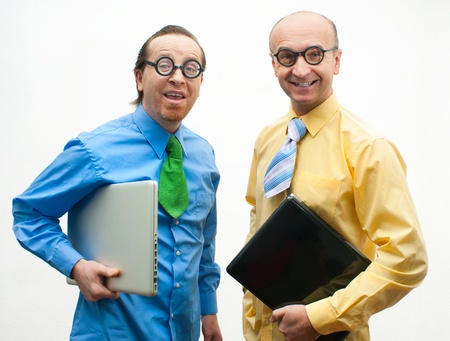 Two crazy businessman with laptopsの写真素材