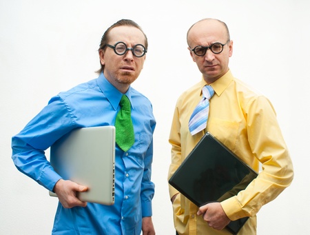 Two thoughtful businessman with laptopsの写真素材