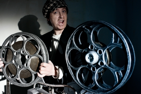Projectionist and film projector with filmの写真素材
