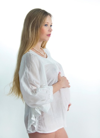 Portrait of beautiful expectant mother in white blouseの写真素材