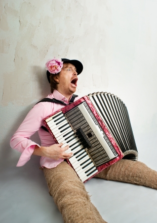 Crazy musician plays the accordionの写真素材