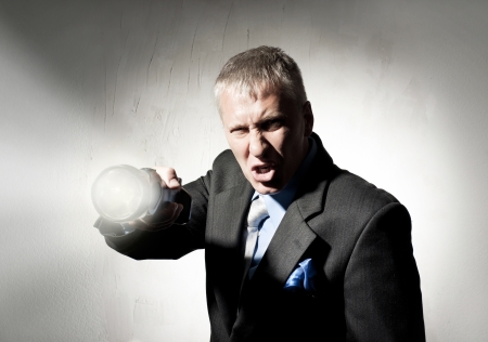 Man in a business suit with a flashlightの写真素材