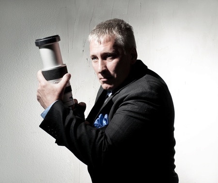 Professional photographer in a suit with a cameraの写真素材