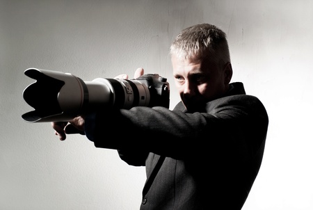 Professional photographer in a suit with a cameraの写真素材