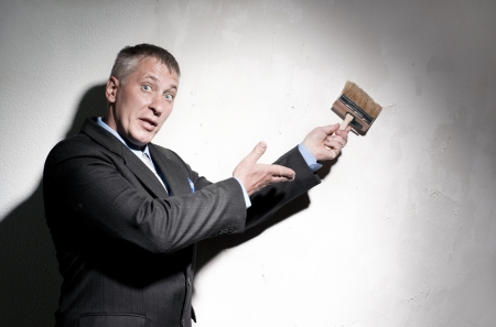Painter in a suit with brush in his handの写真素材