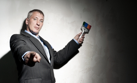 Painter in a suit with brush in his handの写真素材