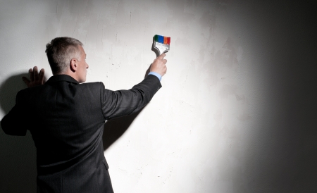 Painter in a suit with brush in his handの写真素材