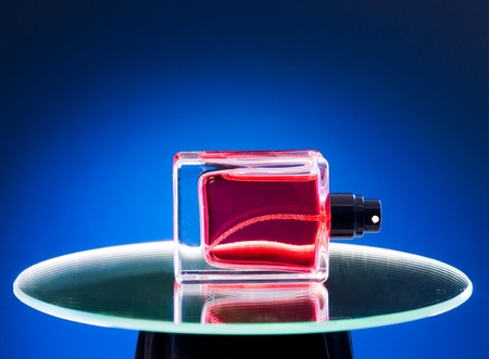 Perfume bottle lies on the mirrorの写真素材