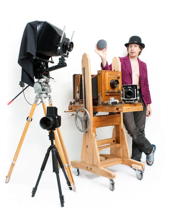 Creative photographer in pink coat with retro cameraの写真素材