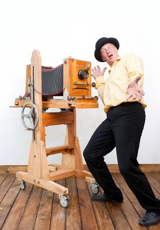 Creative funny photographer with retro cameraの写真素材