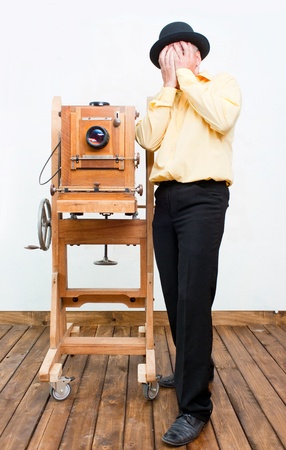 Weary photographer with retro cameraの写真素材