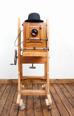 Retro photo camera is on the wooden floorの写真素材